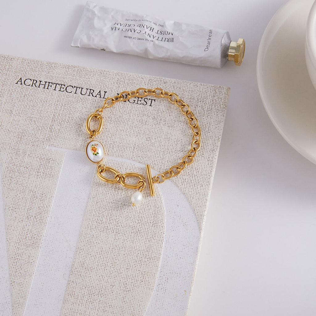 18K gold-plated, lightweight, and luxurious titanium steel bracelet with freshwater pearls.
