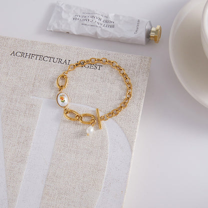 18K gold-plated, lightweight, and luxurious titanium steel bracelet with freshwater pearls.