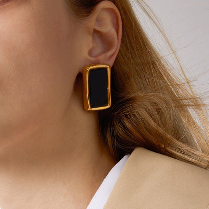 18K gold, black acrylic, and titanium steel stud earrings.