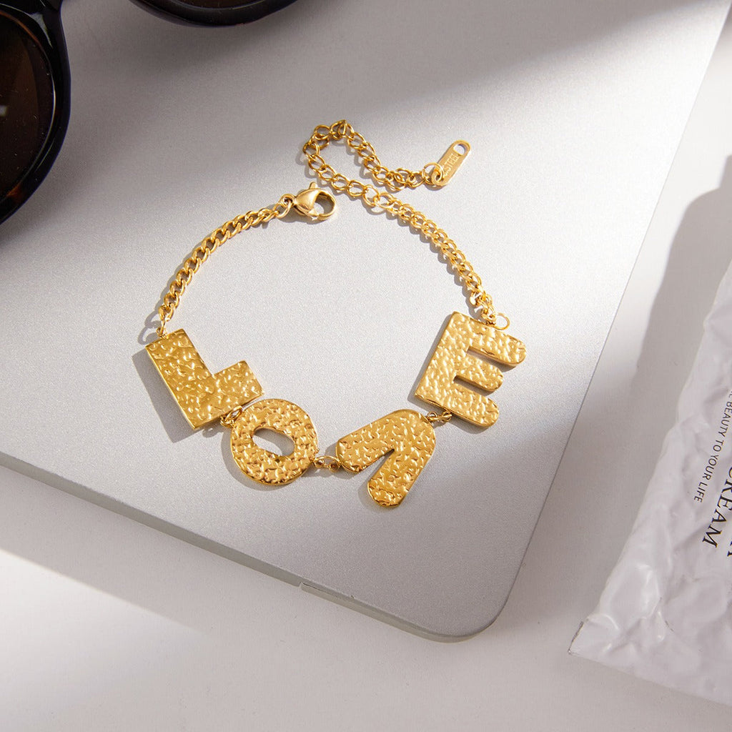 18K gold-plated, lightweight, and luxurious titanium steel bracelet with letter design.