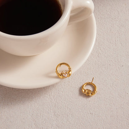 18K gold-plated friendship hand design titanium steel stud earrings with cubic zirconia.