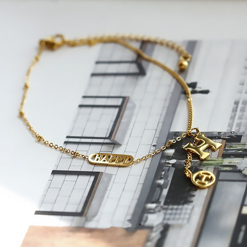 Titanium steel and 18k gold letter H tassel anklet