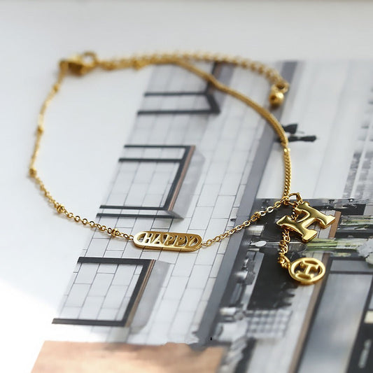 Titanium steel and 18k gold letter H tassel anklet