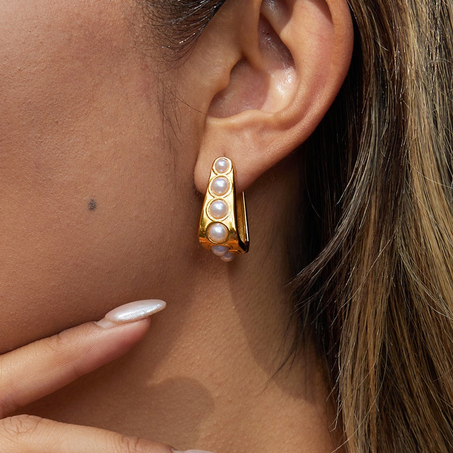 18K gold lightweight luxury earrings with embedded pearls.