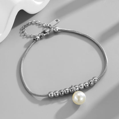 18k gold snake bone beaded anklet with a large heart-shaped heart