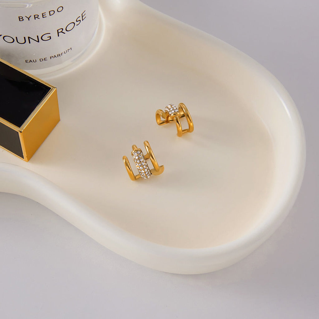 18K gold earrings inlaid with cubic zirconia, in a nail design.
