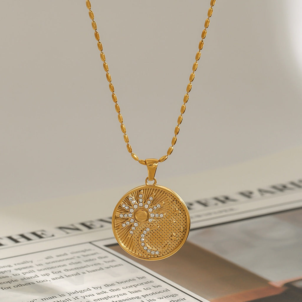 18K gold round necklace with sun and moon pattern and diamond design