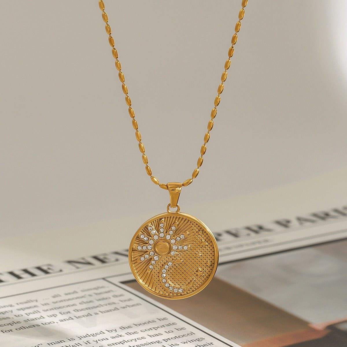 18K gold round necklace with sun and moon pattern and diamond design