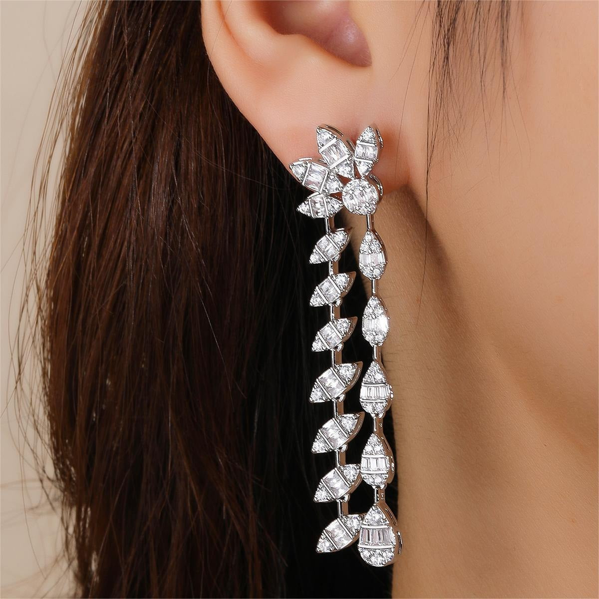 Floral design, fully encrusted with diamonds, double chain leaf earrings.