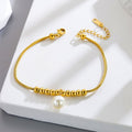 18k gold snake bone beaded anklet with a large heart-shaped heart