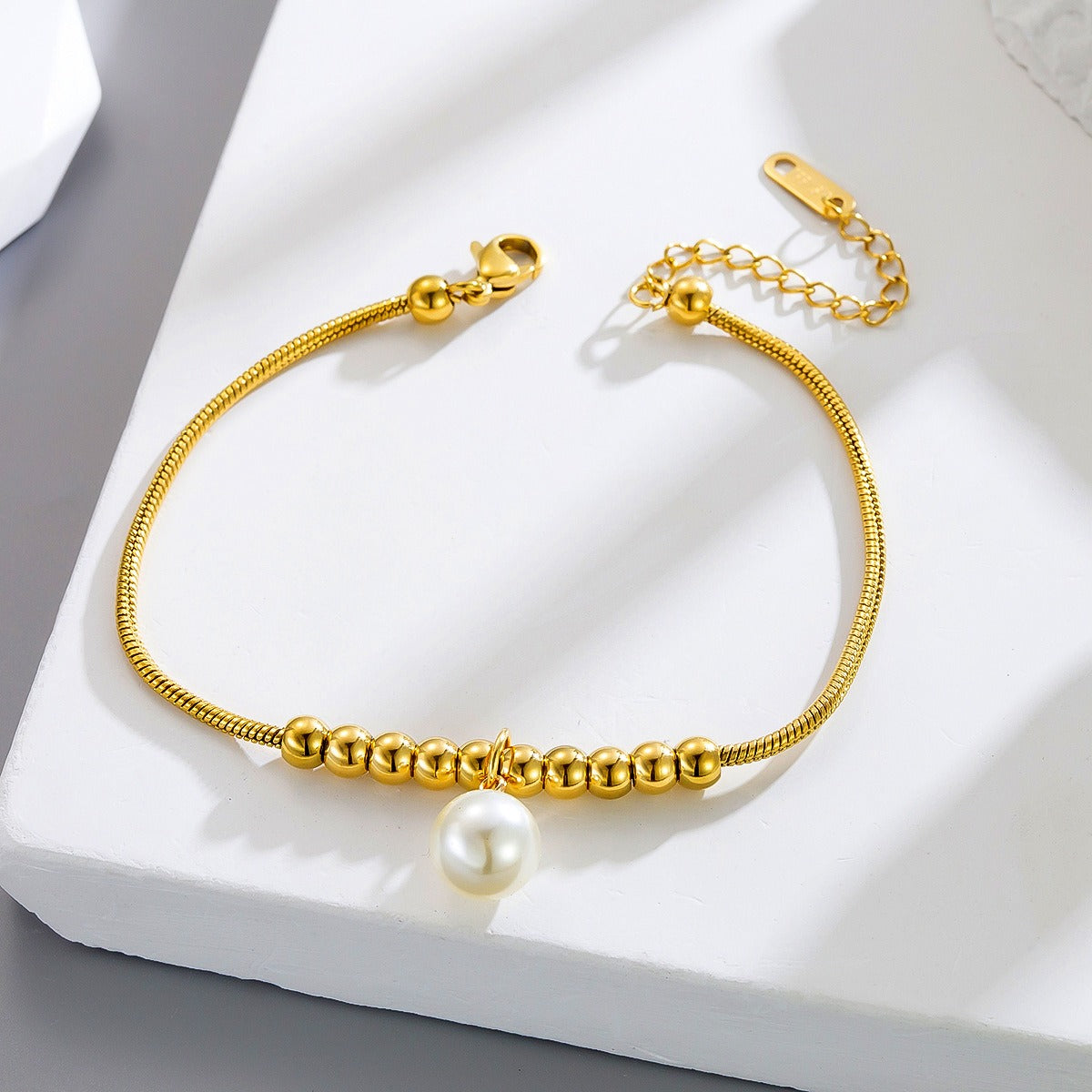 18k gold snake bone beaded anklet with a large heart-shaped heart