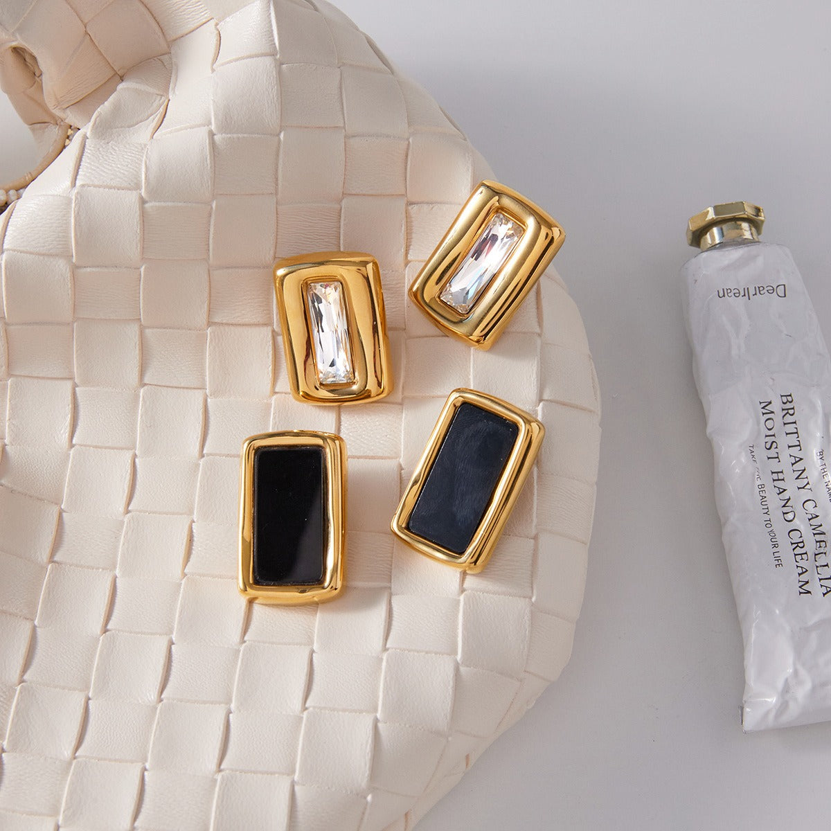 18K gold, black acrylic, and titanium steel stud earrings.