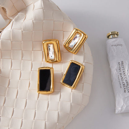 18K gold, black acrylic, and titanium steel stud earrings.