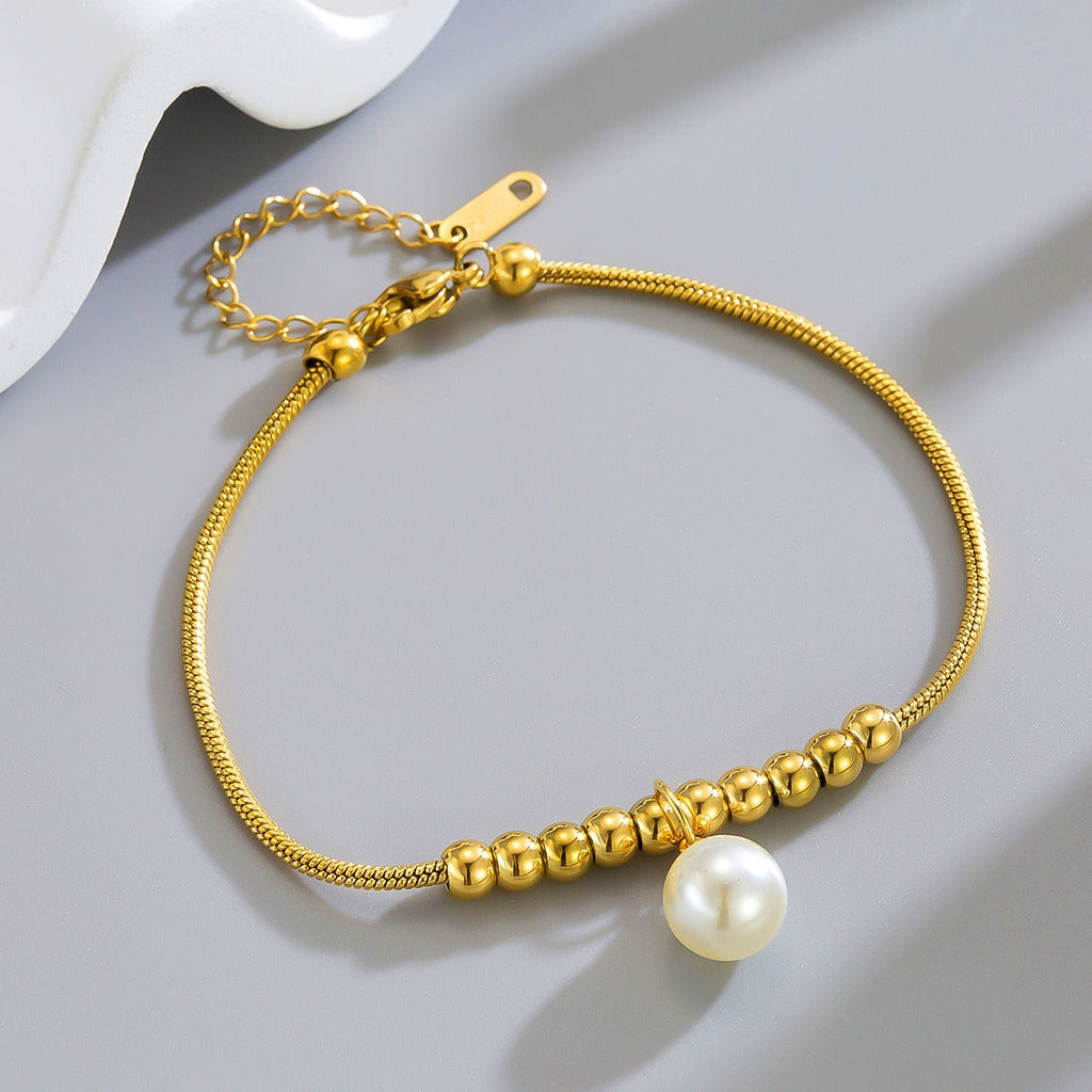18k gold snake bone beaded anklet with a large heart-shaped heart