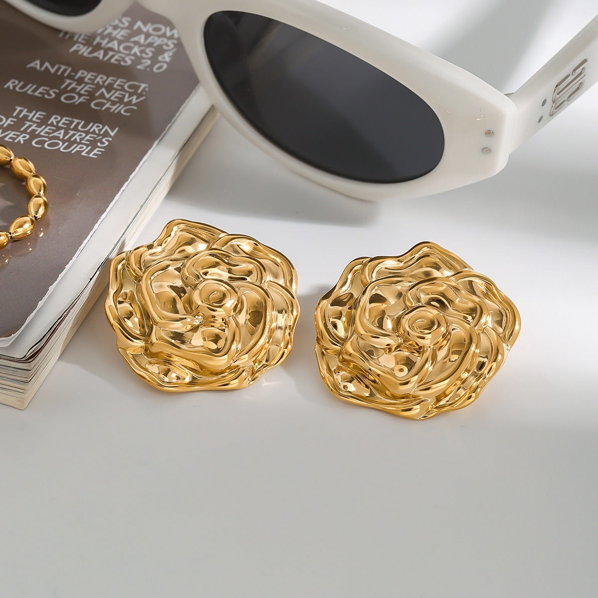 18K gold flower-shaped earrings with textured design