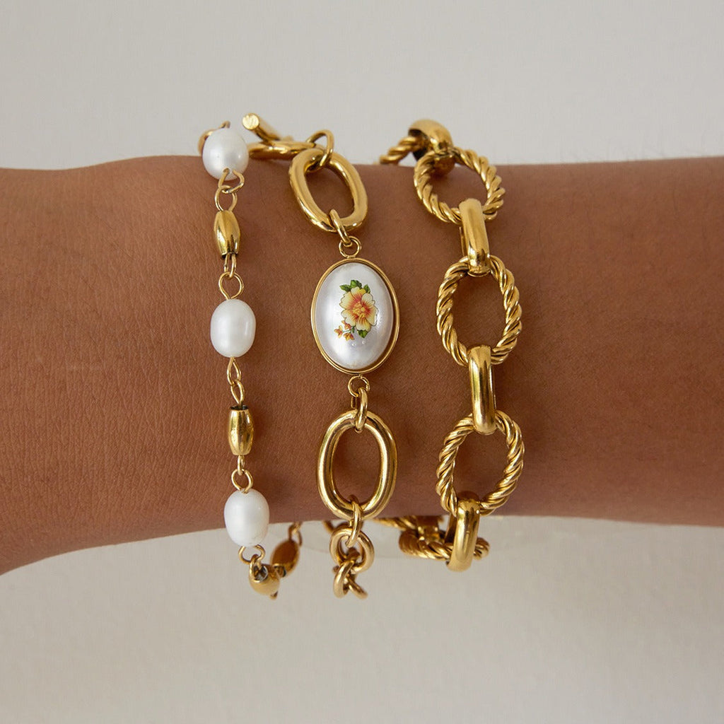 18K gold-plated, lightweight, and luxurious titanium steel bracelet with freshwater pearls.