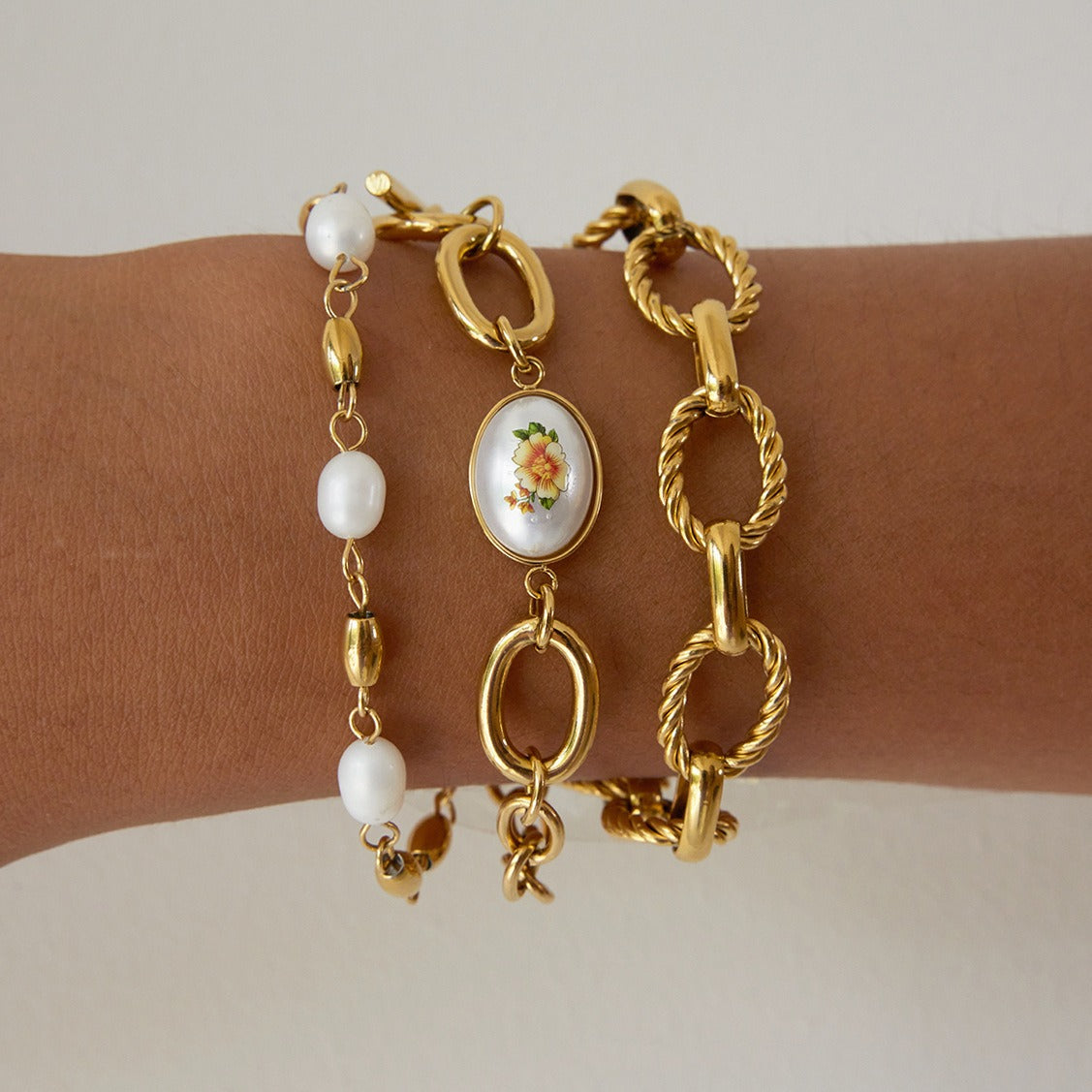 18K gold-plated, lightweight, and luxurious titanium steel bracelet with freshwater pearls.